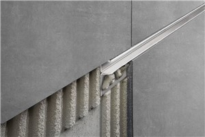 Schluter-DECO-SG is an anodized aluminum, decorative profile featuring a 1/2&quot; (12.5 mm) or 9/16&quot; (15 mm)-wide channel that provides a shadow gap between tile courses or other wall covering. The profile may also be used as a support channel for glass walls, up to a thickness of 3/8&quot; (10 mm) or 1/2&quot; (12.5 mm). DECO-SG features a trapezoid-perforated anchoring leg that is secured in the bond coat beneath the tile.