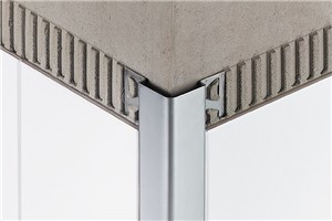 Schluter-ECK-E is a stainless steel edging profile for 90 degree or 135 degree outside corners of tiled walls that offer excellent edge protection against mechanical stresses; for example, in industrial kitchens and hospitals. In addition, the profiles produce a radiused edge along the outside wall corner for a clean, decorative finish. ECK-E features trapezoid-perforated anchoring legs that are secured in the mortar bond coat beneath the tile. ECK-E is especially suitable for areas where strict hygienic requirements must be met (e.g., hospitals, industrial kitchens, clean rooms, washrooms, and food-processing plants) and where aesthetic appeal is desired.